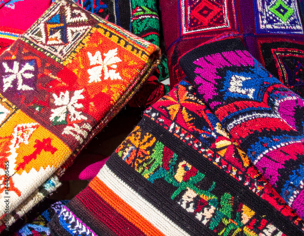 A vibrant display of hand-knitted Chilean wool textiles with intricate indigenous patterns, showcasing traditional craftsmanship and cultural heritage. A vibrant display of hand-knitted Chilean wool textiles with intricate indigenous patterns, showcasing traditional craftsmanship and cultural heritage.