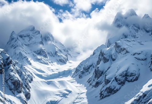 Jagged snow-laden peaks shrouded in swirling snow, fierce wind whipping across icy slopes, dramatic lighting, storm photo