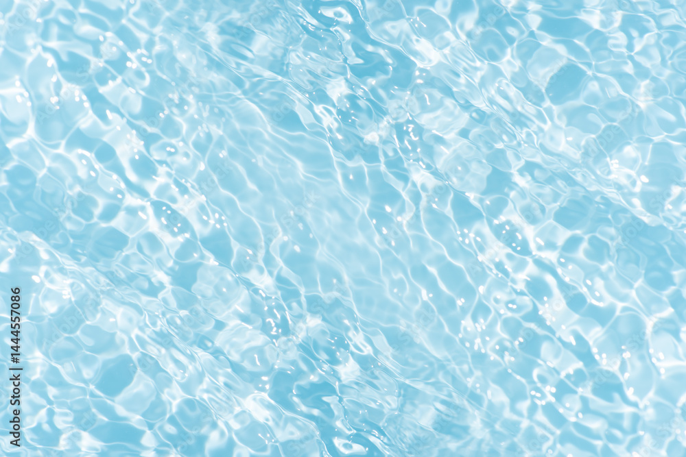 Obraz premium Blue water with ripples on the surface. Defocus blurred transparent blue colored clear calm water surface texture with splashes and bubbles. Water waves with shining pattern texture background.