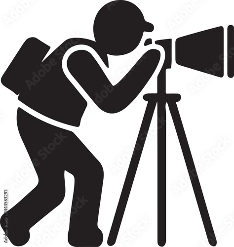 A black silhouette of a photographer with his camera and tripod suggests a professional cameraman at work