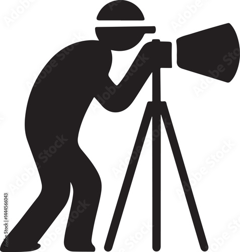 A professional photographer with a camera on a black tripod uses photography equipment in a studio