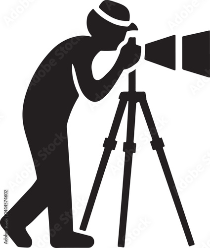 A black silhouette of a professional photographer with a camera on a tripod uses photography equipment in a studio