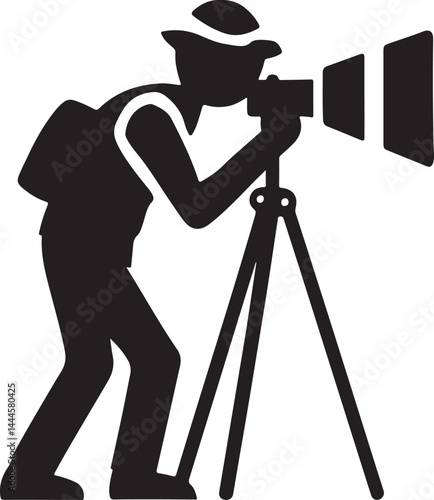 A black silhouette of a professional photographer with a digital camera on a tripod captures a photo in the studio
