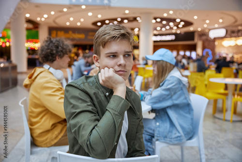 Portrait of upset teenage boy suffering from bullying of friends