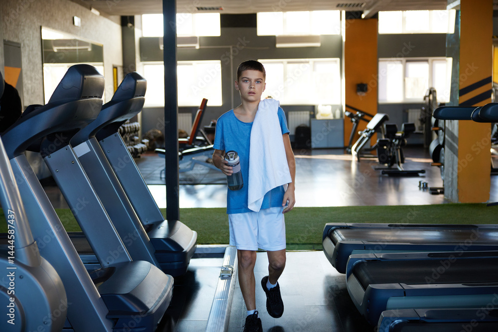 Teenager boy preparing for cardio training workout at sport center
