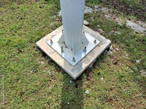 Photos The strong base of the lamp post is made of concrete.