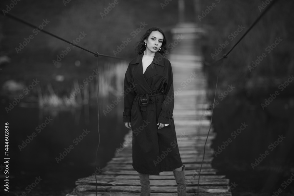 beautiful brunette european girl in blue trench coat at nature. Young lady with beautiful face.