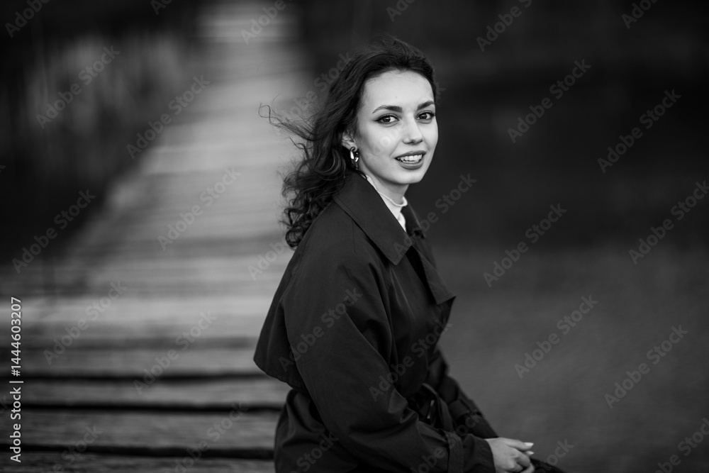 beautiful brunette european girl in blue trench coat at nature. Young lady with beautiful face.