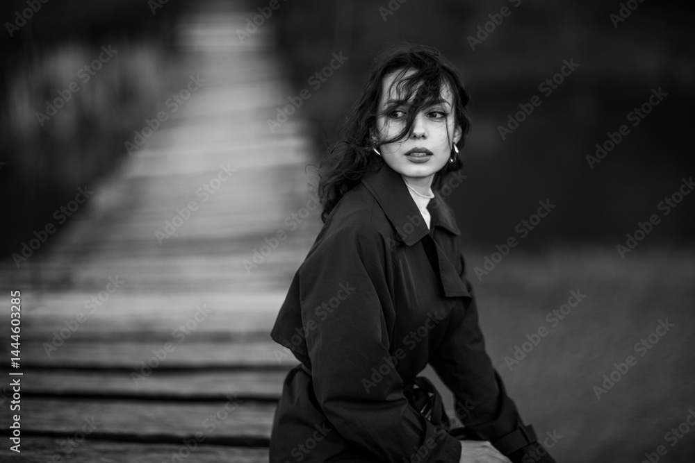 beautiful brunette european girl in blue trench coat at nature. Young lady with beautiful face.