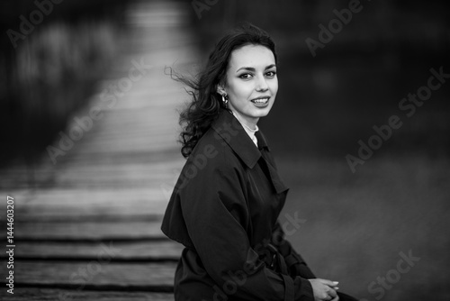 Obraz na płótnie beautiful brunette european girl in blue trench coat at nature. Young lady with beautiful face. w salonie