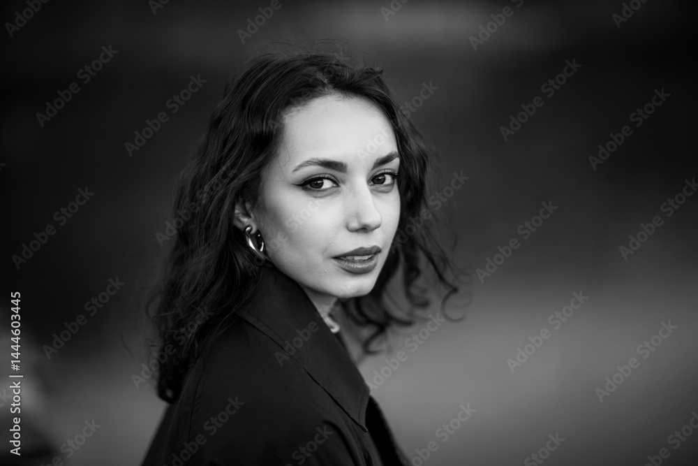 beautiful brunette european girl in blue trench coat at nature. Young lady with beautiful face.