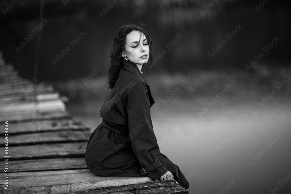 beautiful brunette european girl in blue trench coat at nature. Young lady with beautiful face.