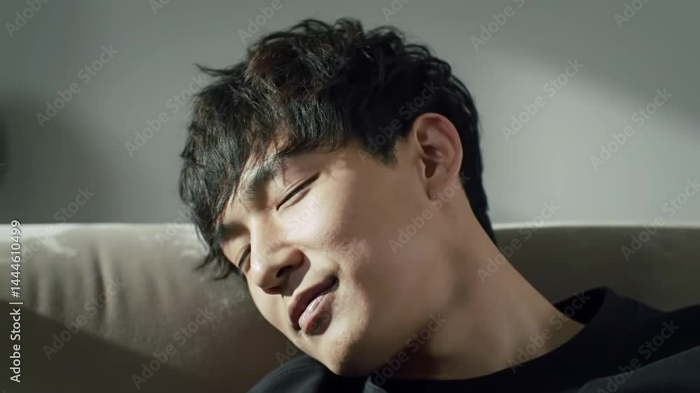 Asian man sleeping on sofa at home Asian man sleeping on sofa at home