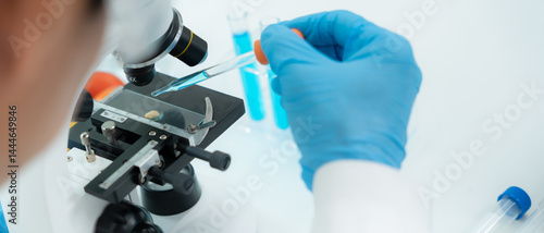 Scientist analyze biochemical samples in advanced scientific laboratory. Medical professional use microscope look microbiological developmental of viral. Biotechnology research in science lab.