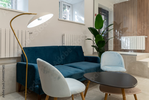 a beautiful lobby in a hotel or luxury house. bright walls, cozy sofas, green indoor plants. the atmosphere of hospitality and comfort.