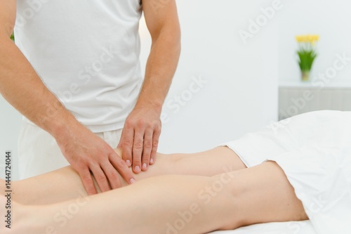Wallpaper Mural Woman enjoying professional body massage at a modern spa salon. Relaxed young lady lying on a massage table while a skilled masseur is gently massaging her back. Beauty, health, pleasure, concept Torontodigital.ca