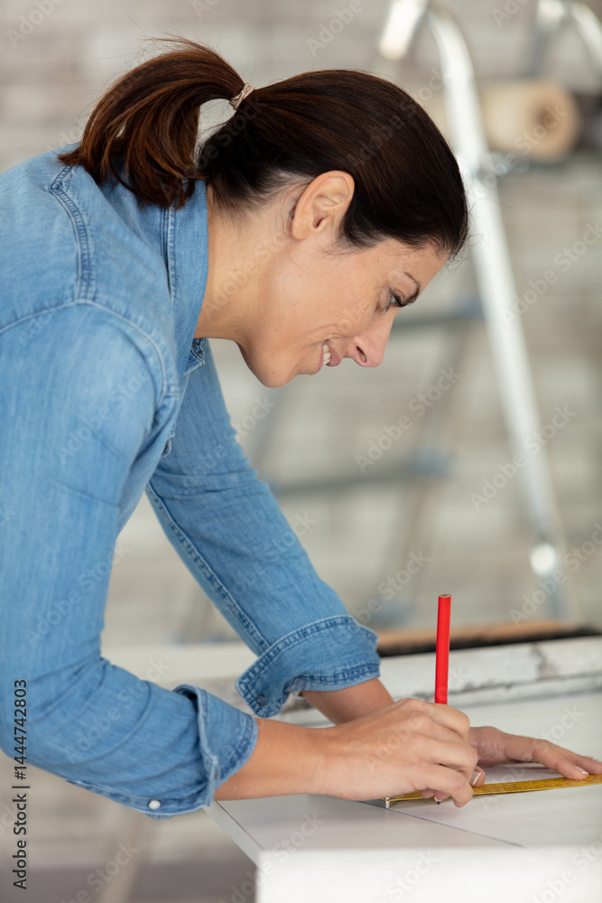 female repairman carpenter concentrated on her work