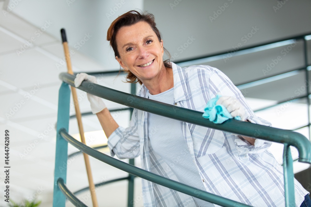 happy cleaner smiling while cleaning office