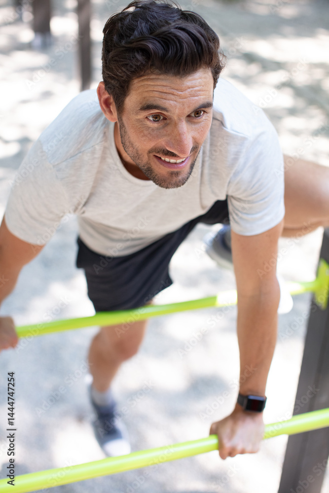 man doing exercise gym outdoor bars