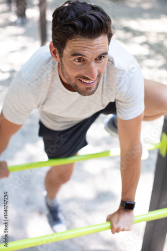 man doing exercise gym outdoor bars