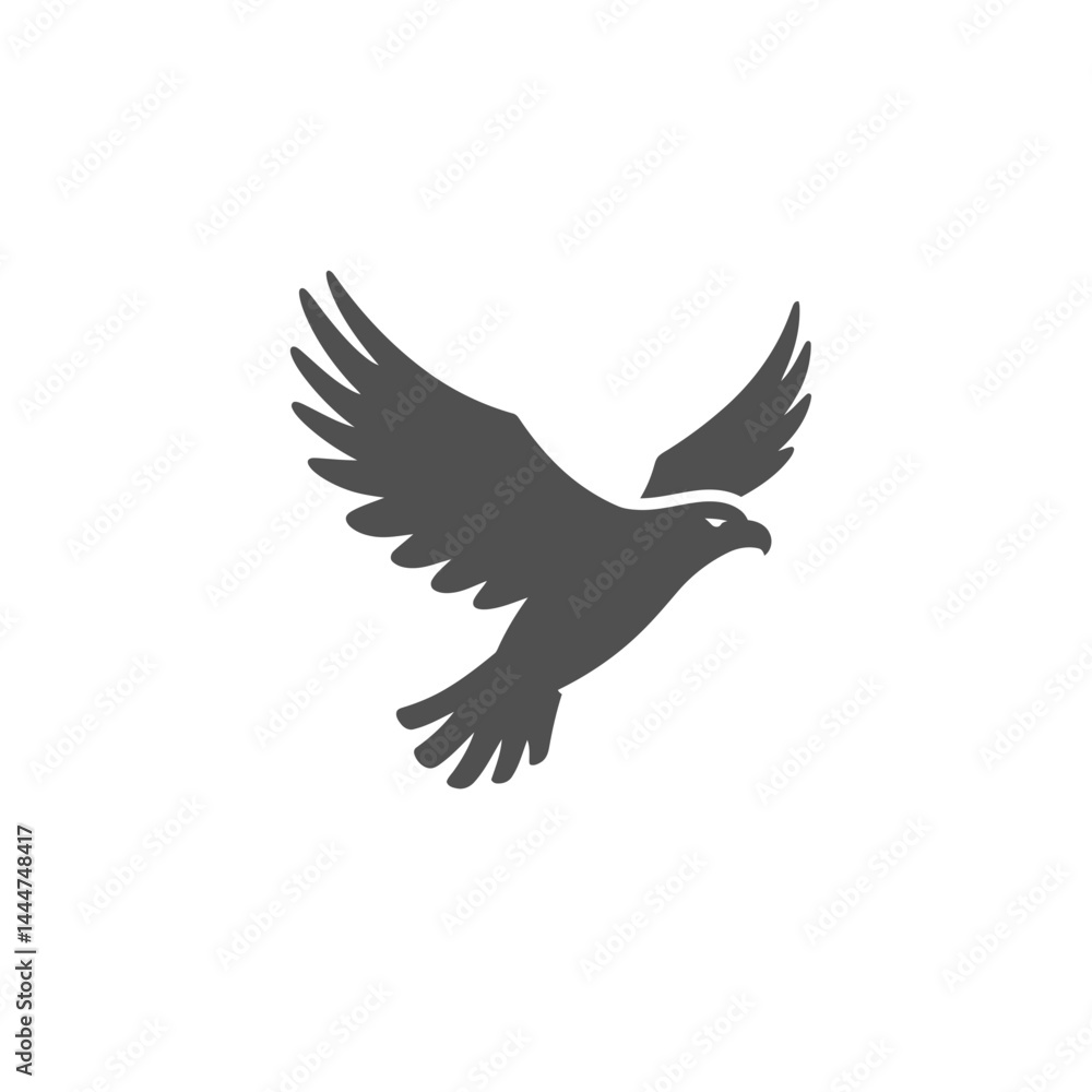 Obraz premium Soaring Silhouette: A striking monochrome silhouette of an eagle in mid-flight, set against a clean background, embodying freedom, power, and majestic grace.