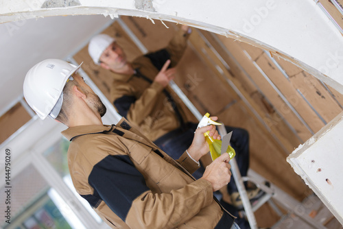 Obraz na płótnie portrait of two builder working indoor w salonie