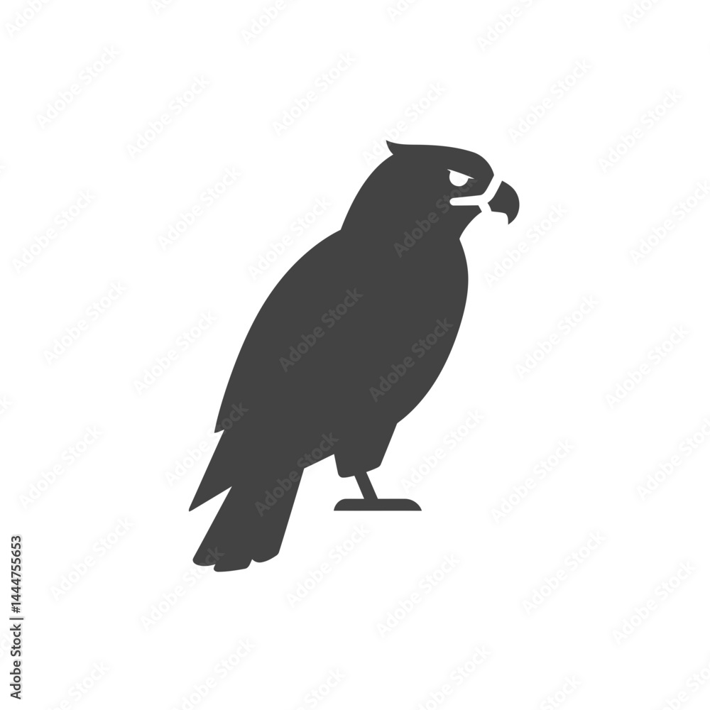 Obraz premium Majestic Silhouette of a Hawk: A sleek silhouette of a hawk stands proudly, exuding an air of dominance and keen observation, embodying strength and freedom.