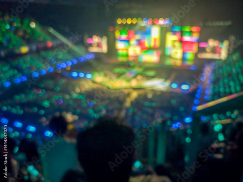 Blurred images of the atmosphere of light, color, sound, and a grand concert performance in a spacious hall.