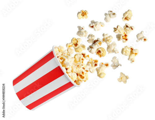 Obraz na płótnie Popcorn spilling from a classic striped container on isolate background. w salonie