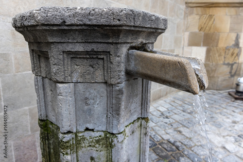 Rustic scene of an old stone fountain flowing with water, Baku