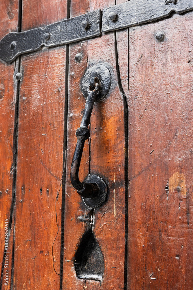 Rustic door knocker on a wooden surface, Baku