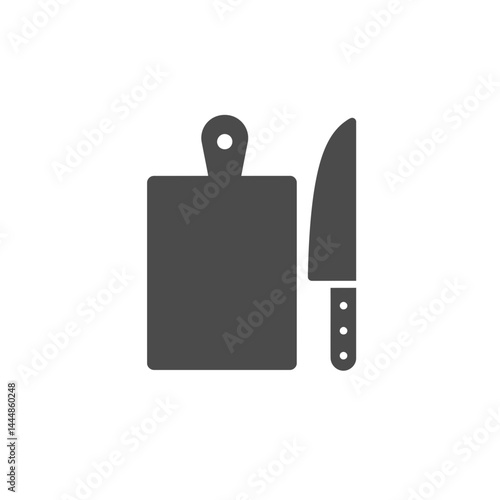 Kitchen Essentials: A minimalist, high-angle view showcases a cutting board and sharp knife, embodying the core of culinary preparation, clean and functional.