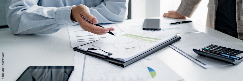 Startup business people teamwork calculating a valuation in workplace Startup business people teamwork calculating a valuation in workplace