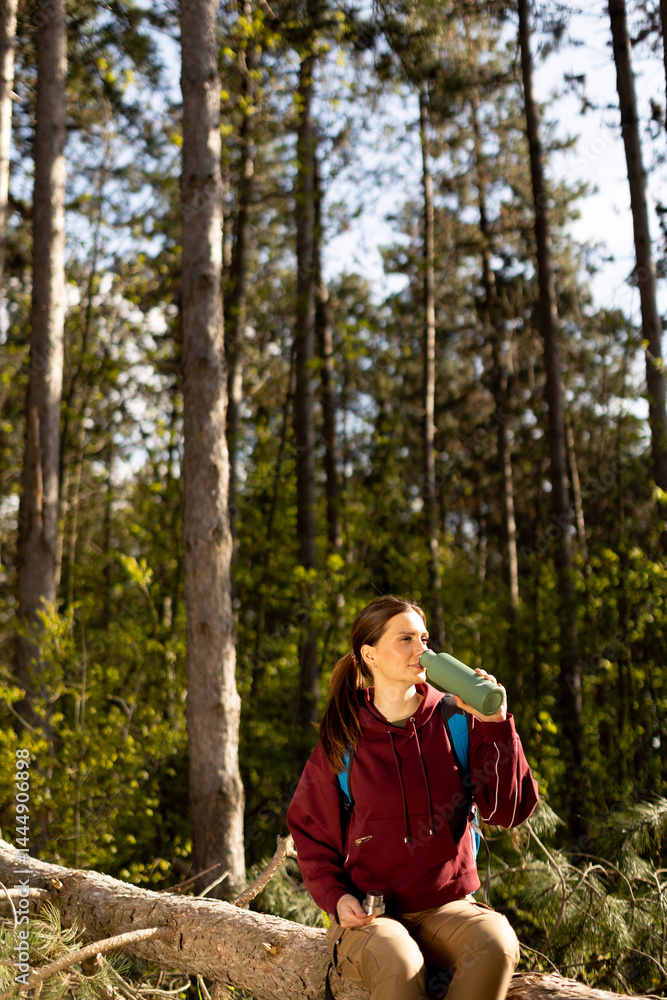 Exploring the tranquility of the forest while enjoying a refreshing moment at midday