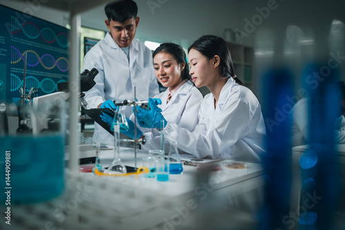Fotografie Research team analyzing experiment results with glassware and chemicals in a mod