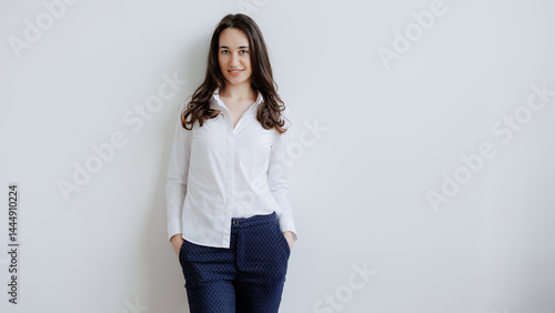 Obraz na płótnie Woman posing confidently in a stylish outfit against a neutral backdrop in a well-lit environment w salonie