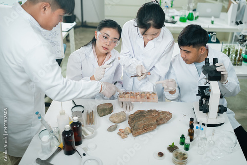 Geology researchers analyze various types of rocks and minerals in a laboratory setting, focusing on the classification of geological samples for energy resources and academic scientific purposes