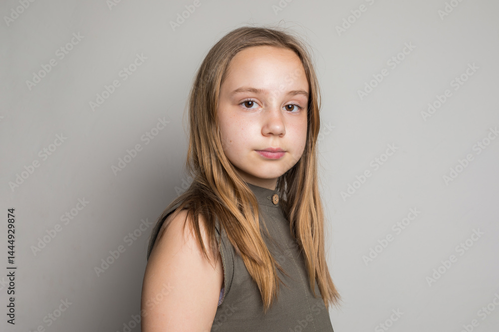 Fototapeta premium Beautiful young child girl standing against white wall background