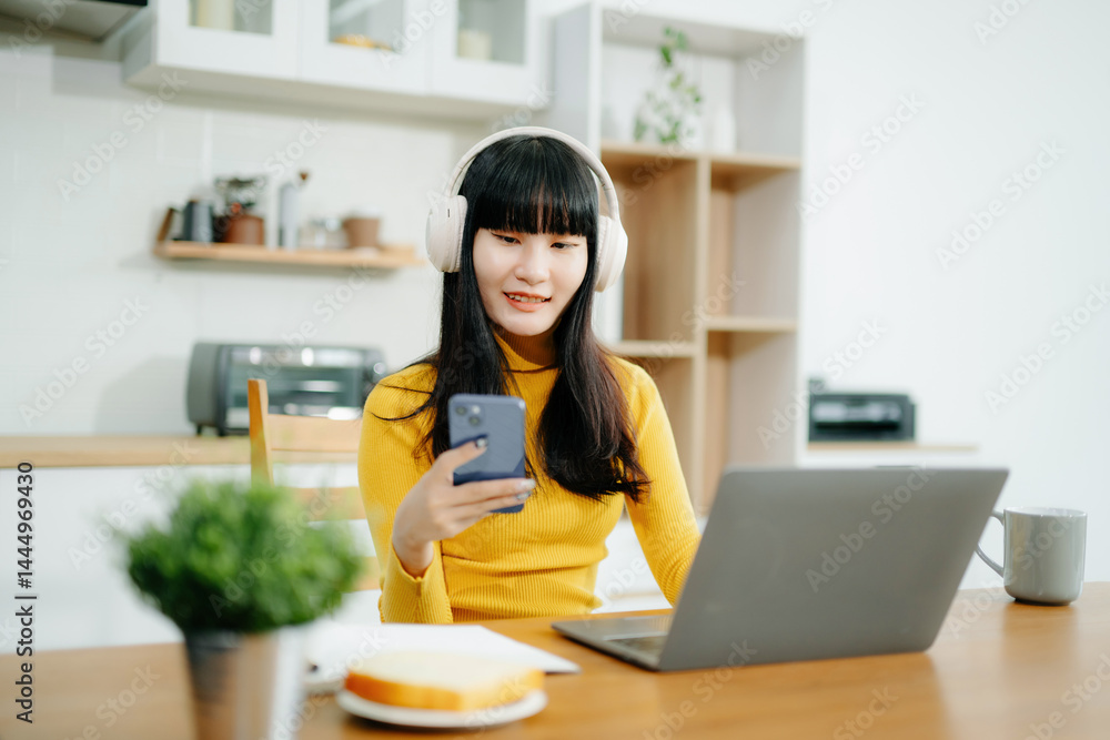 Woman using laptop checking email news online sitting on sofa, working on computer, writing blog Woman using laptop checking email news online sitting on sofa, working on computer, writing blog