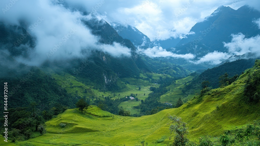 Fototapeta premium Verdant valley shrouded in clouds, cascading hills in a mountain landscape