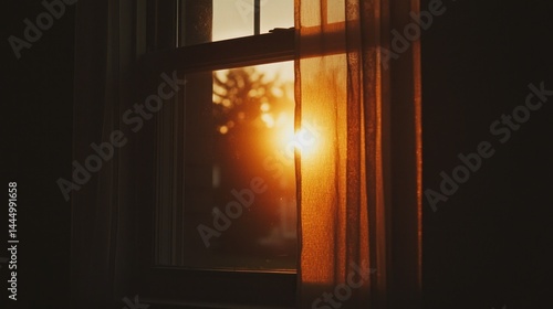 Bright sunlight streams through a window with a curtain