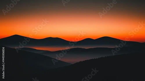 Wallpaper Mural Silhouetted mountain ranges are under a vibrant orange sunset sky Torontodigital.ca