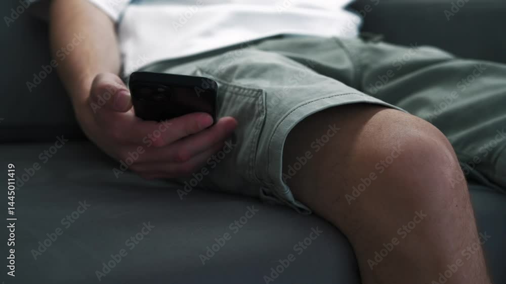 Incoming call on mobile phone.
Work call.
Man with phone sitting on sofa.
Black cell phone.
Time on phone Incoming call on mobile phone.
Work call.
Man with phone sitting on sofa.
Black cell phone.
Time on phone