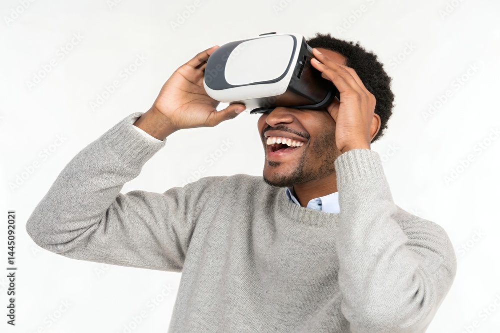 Man with vr headset laughing and holding the device to his head in front of a white background Man with vr headset laughing and holding the device to his head in front of a white background