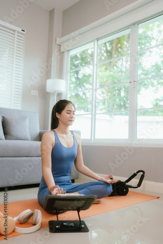 Confident young Asian woman practices yoga at home on exercise mat, embracing wellness, balance, and fitness through online training Free Download Confident young Asian woman practices yoga at home on exercise mat, embracing wellness, balance, and fitness through online training - GFXLoad