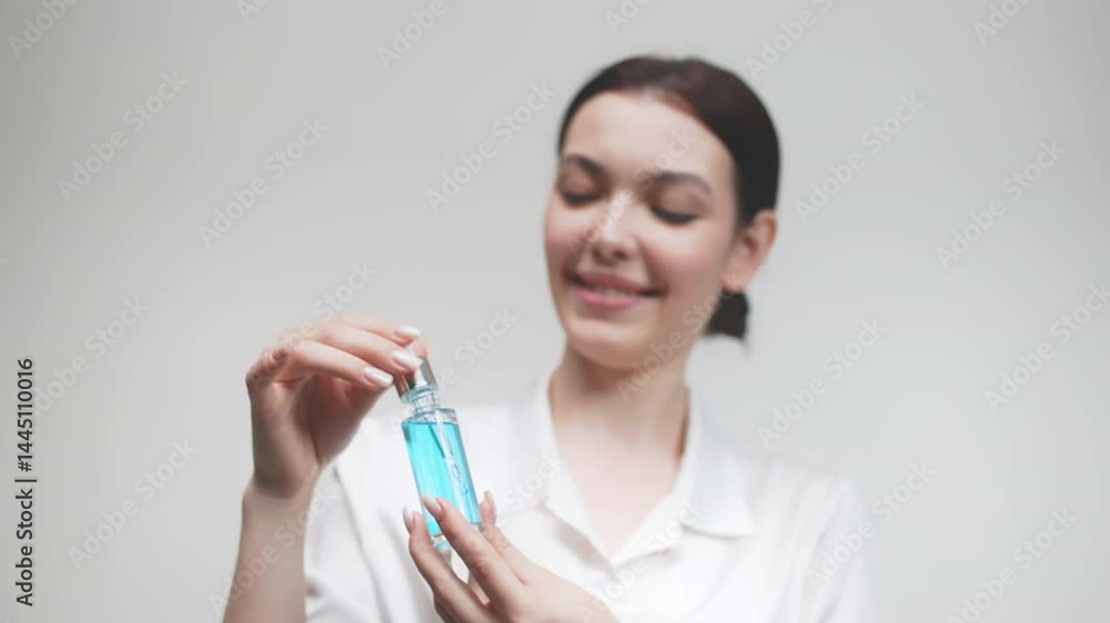 Beautiful woman with naturally clear and fresh skin, enjoying anti-aging collagen serum in her hands. Serum with active botanical ingredients vitamin C in a dropper. Beautiful woman with naturally clear and fresh skin, enjoying anti-aging collagen serum in her hands. Serum with active botanical ingredients vitamin C in a dropper.