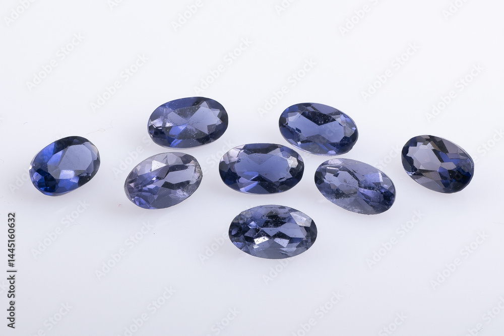 Set of Eight Polished Oval Sapphire Gemstones on a White Background