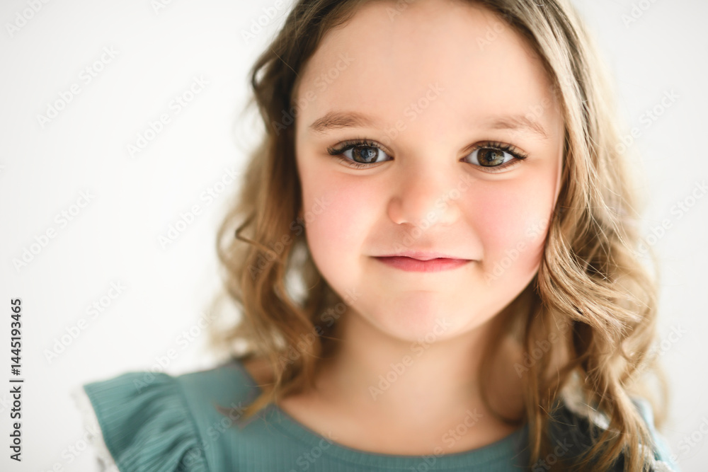 Portrait of a cute 6 or 7 years old girl over white background Portrait of a cute 6 or 7 years old girl over white background