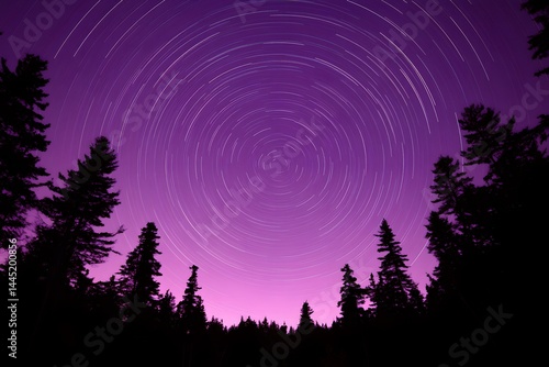 Night sky star trails over silhouetted pine trees A breathtaking long exposure photograph showcasing a purple night sky
