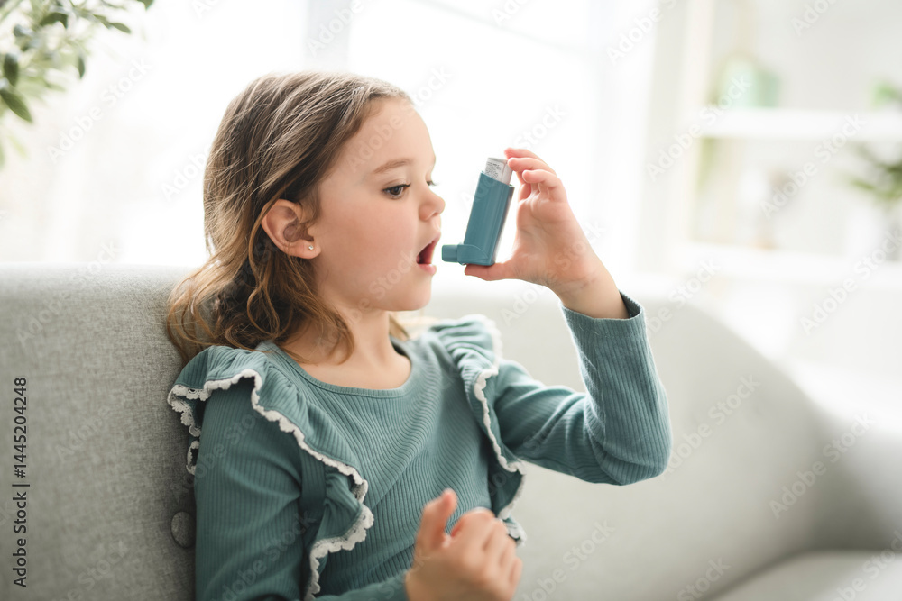 cute child having breathing problems and using an asthma inhaler cute child having breathing problems and using an asthma inhaler